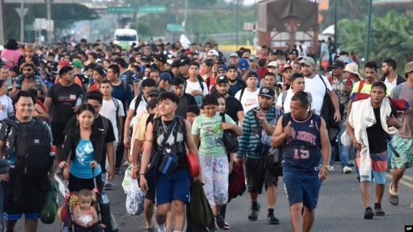 Migrants walk along the highway through Suchiate, Chiapas state in southern Mexico, July 21, 2024, during their journey north toward the U.S. border.